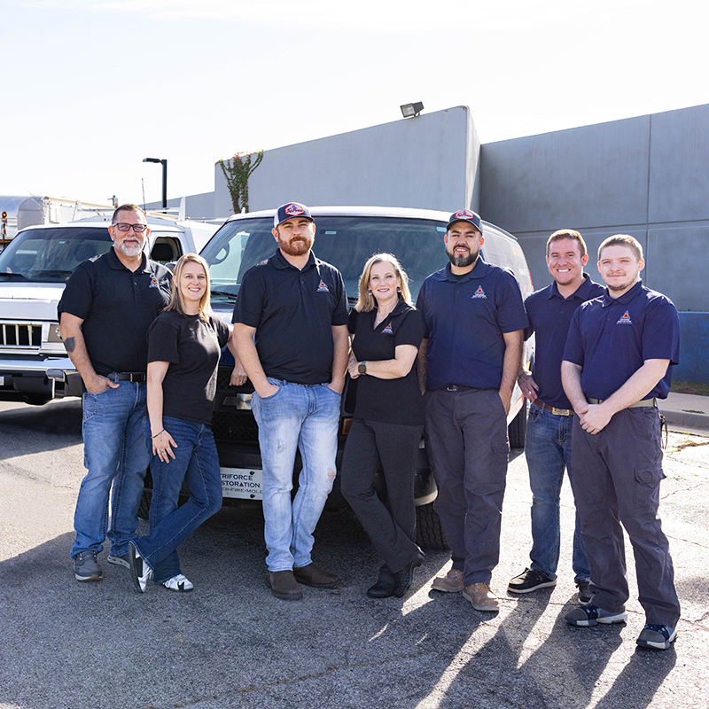 TriForce Restoration team standing in front of service vehicles as a trusted Oklahoma restoration company
