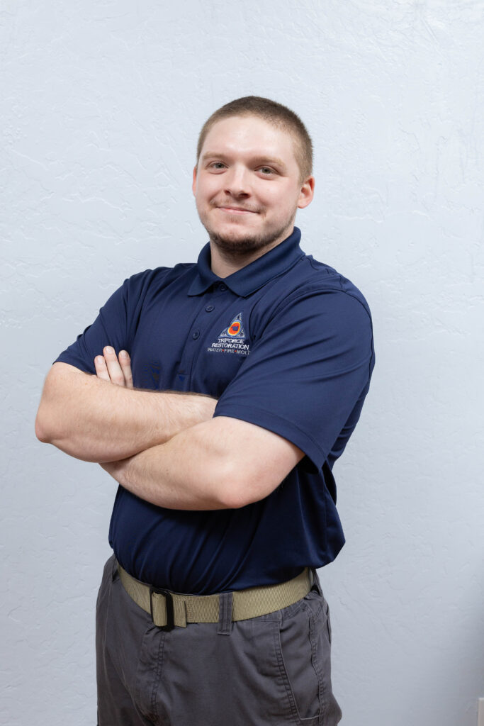 Confident restoration contractor technician representing water removal expertise at a trusted water mitigation company.