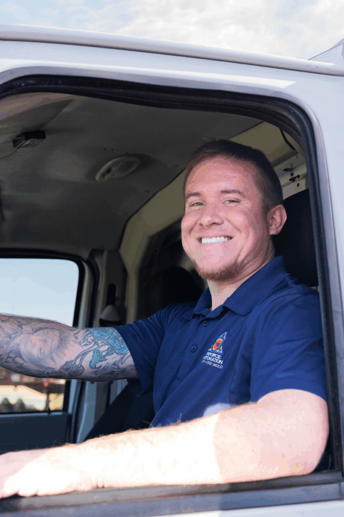 Restoration contractor technician driving a service vehicle to respond to water removal calls for a professional water mitigation company.